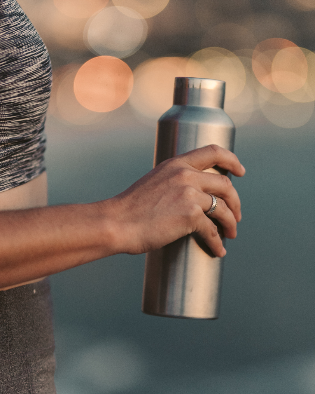 man holding stainless steel tumbler, ways to reuse and recycle